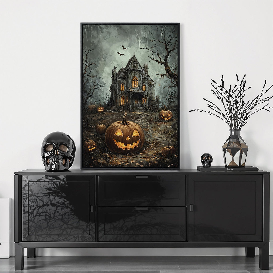 Framed Wall Art: Spooky Halloween scene with haunted house and glowing pumpkins. Dark, moody color palette perfect for fall decor.