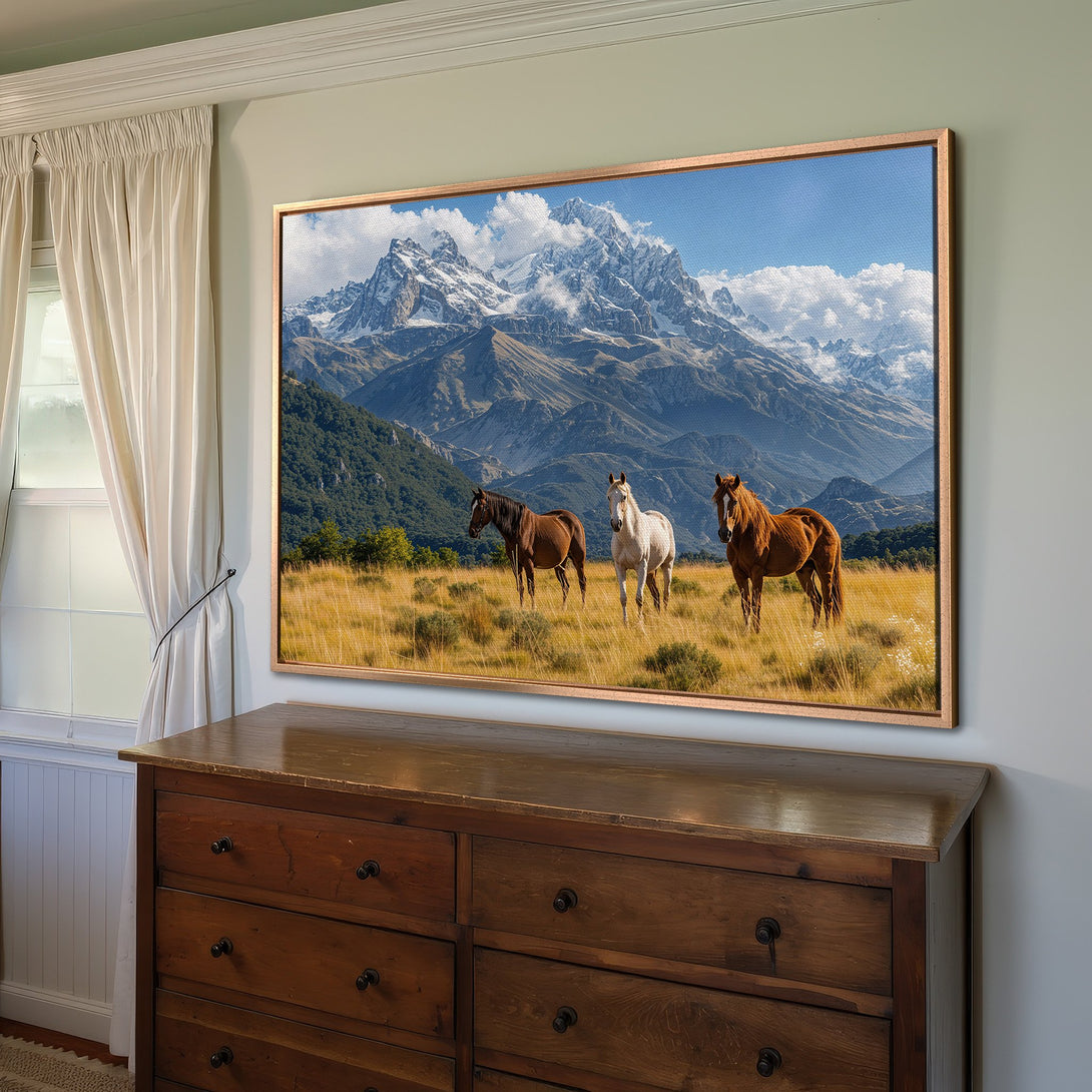 Framed Wall Art: Majestic horses in a mountain landscape. Warm tones of brown, gold, and blue create a serene, natural aesthetic. Perfect for any home!