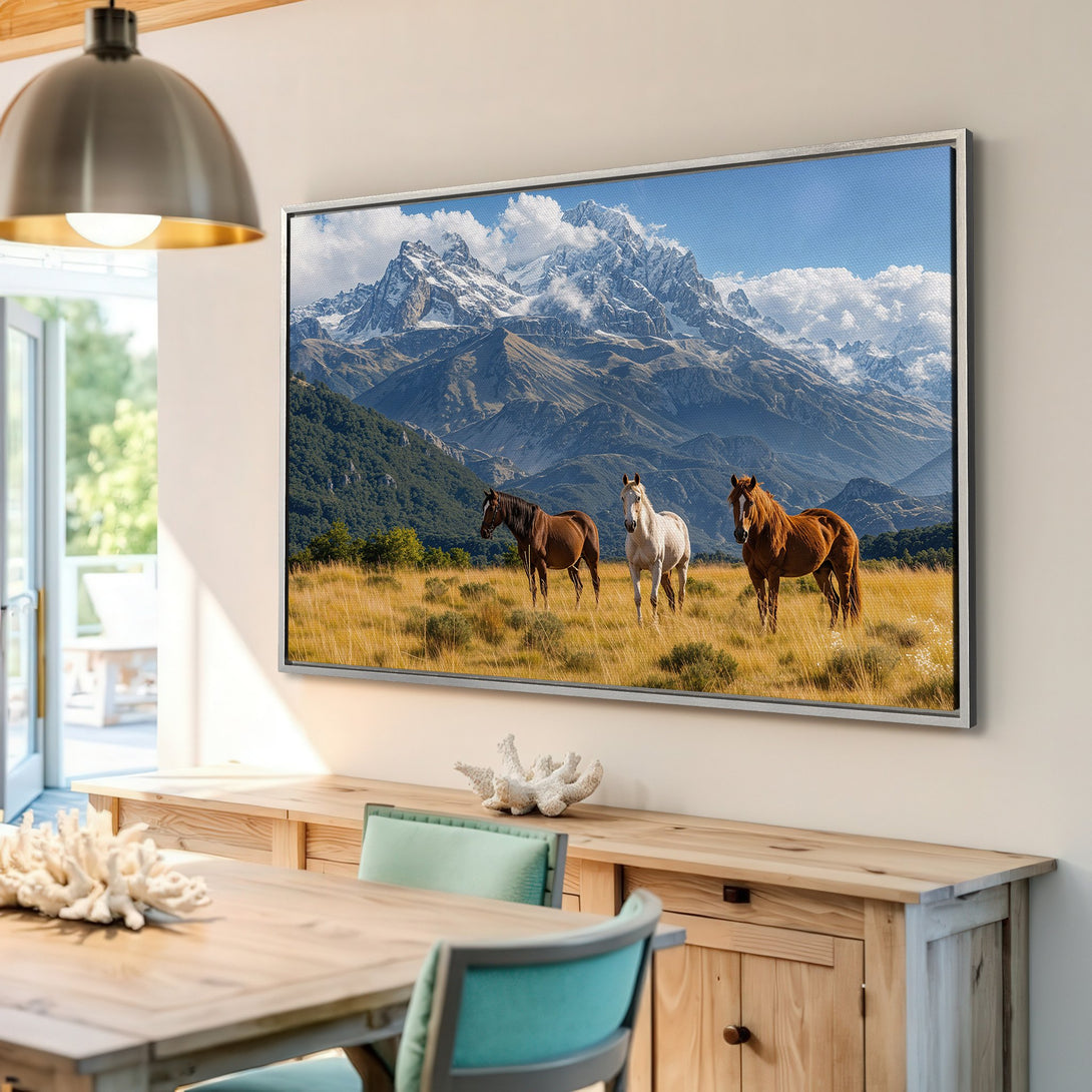 Framed Wall Art featuring horses in a mountain landscape. Earthy tones of brown, blue, and gold create a serene and stylish interior accent.