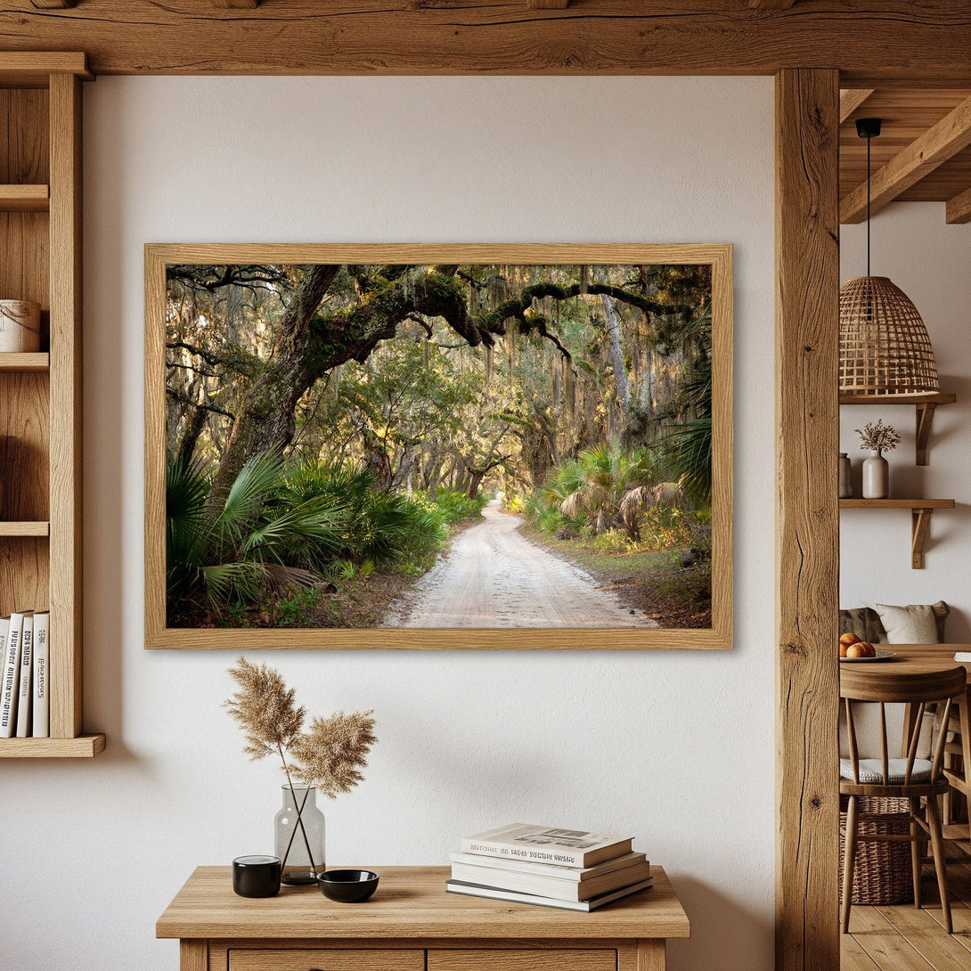 Framed Poster featuring a scenic dirt road through a lush forest, warm earth tones. Rustic style wall art for your home.