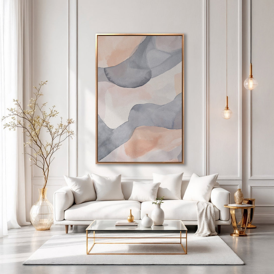 Framed Wall Art: Abstract watercolor painting in neutral tones (gray, blush, beige) with gold frame, displayed in a modern living room. Elevate your space!