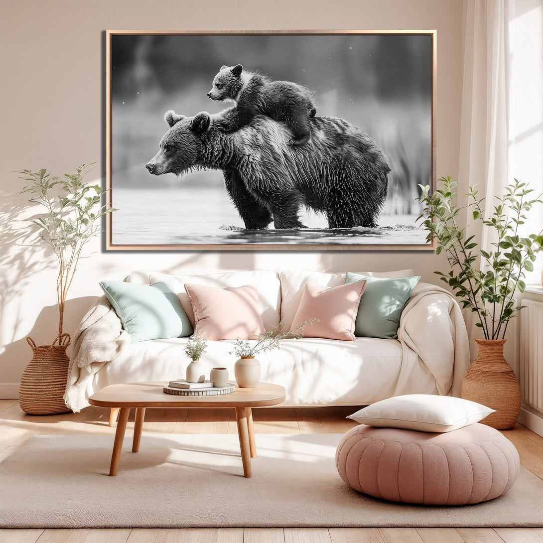 Framed Wall Art: Black and white photo of a bear and cub in a serene setting. Perfect for adding a touch of nature to your home decor. Neutral color palette.