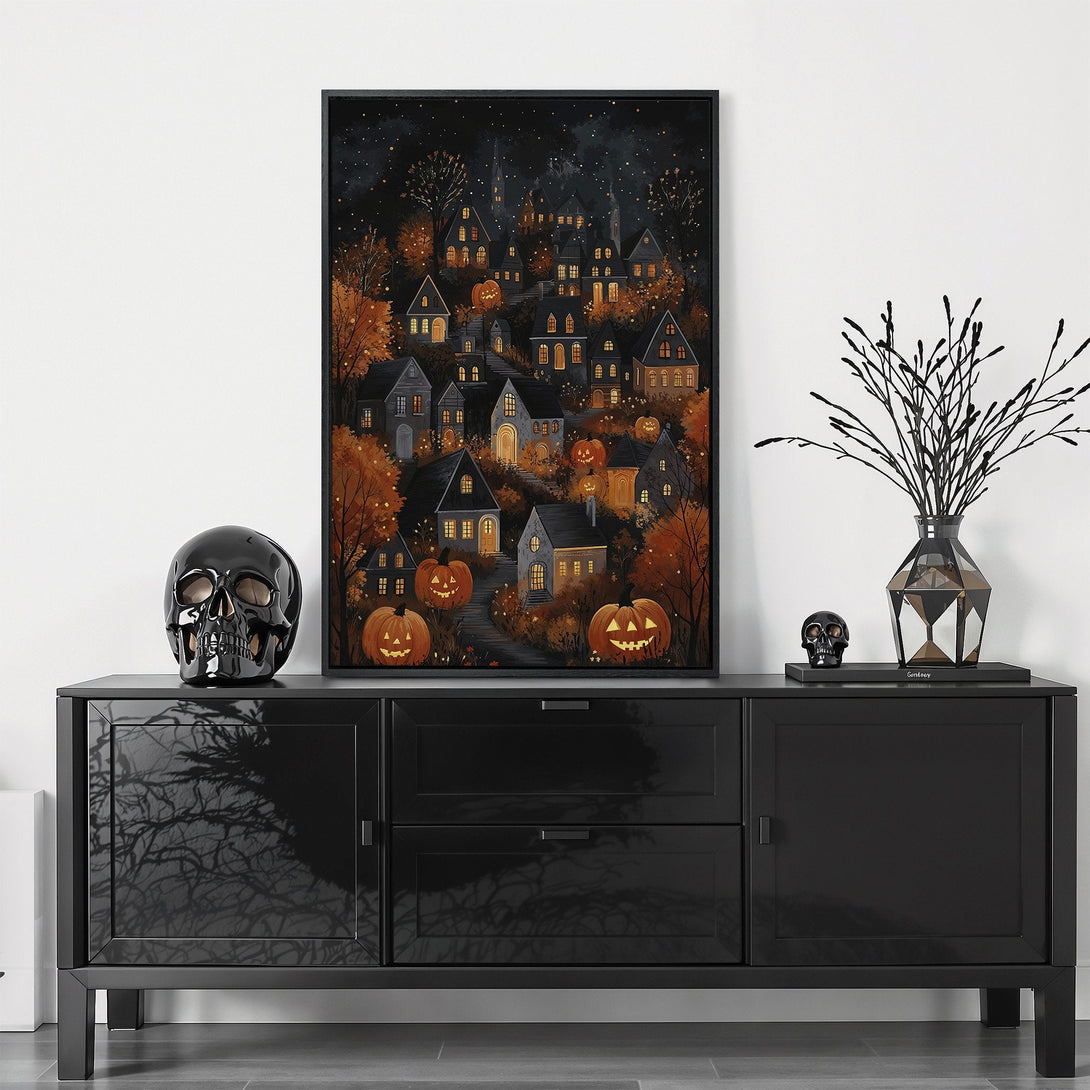 Framed Wall Art: Spooky Halloween village scene in warm orange and black hues. Perfect fall decor for a cozy, yet eerie vibe.