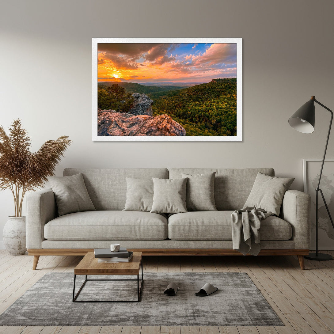 Framed Poster of a vibrant sunset over a mountain landscape. Warm orange and blue hues create a stunning nature scene, perfect for home decor.