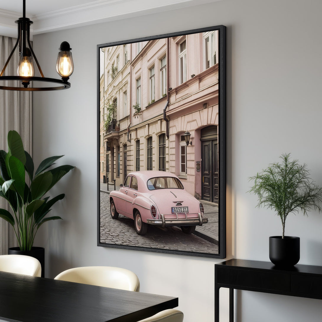 Framed Wall Art: Vintage pink car on European street. Pastel color palette adds a touch of nostalgia. Perfect for adding charm to your home decor.