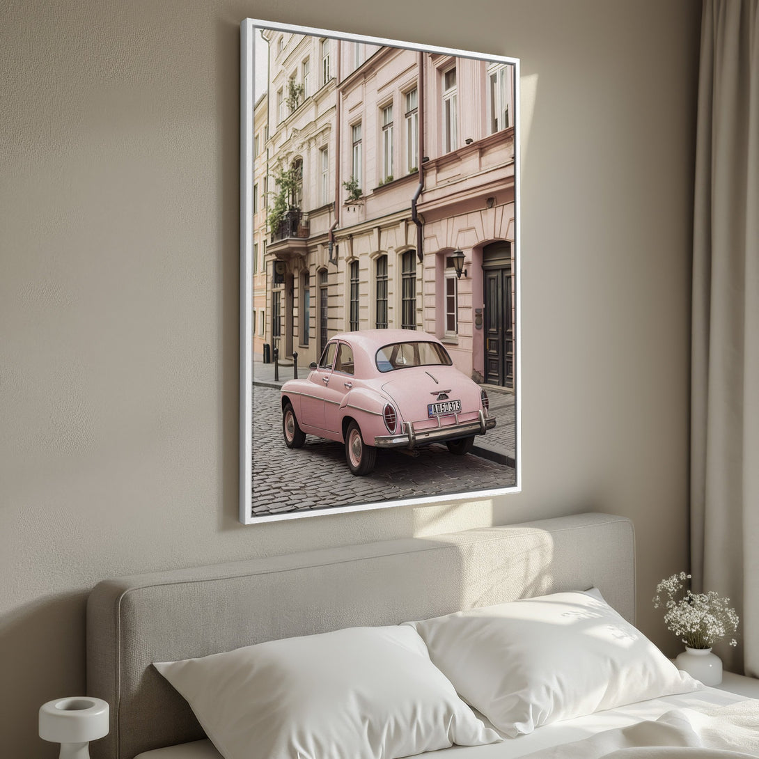 Framed Wall Art featuring a vintage pink car on a cobblestone street. Soft, muted pastel color palette. Perfect for adding a touch of nostalgia.