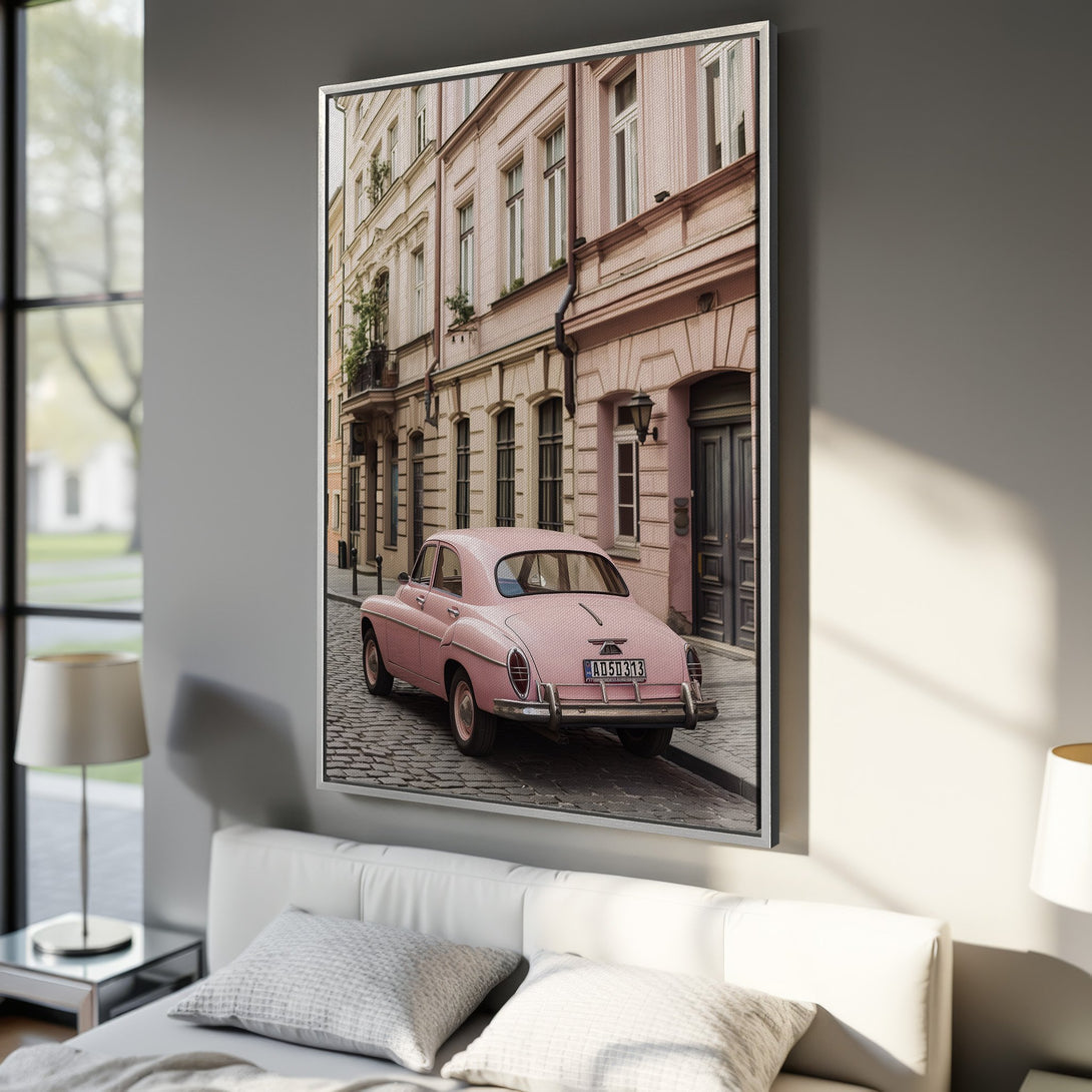 Framed Wall Art: Pink vintage car parked on a cobblestone street. Pastel color palette, European architecture. Perfect for adding a touch of vintage charm.