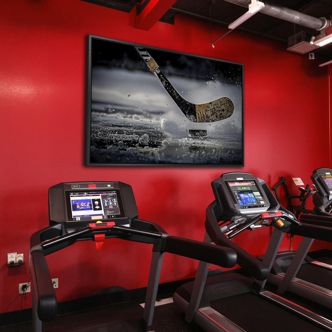 Framed Wall Art: Hockey action canvas print with a black frame, displayed in a gym with red walls. Dramatic, action-packed art with a black, white, and grey color palette.