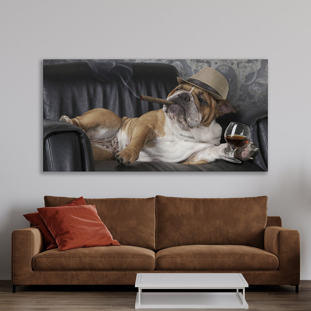 Framed Wall Art: Bulldog in a hat, smoking a cigar, relaxing on a black leather couch. Warm, neutral color palette. Perfect for adding a touch of humor to your home decor!