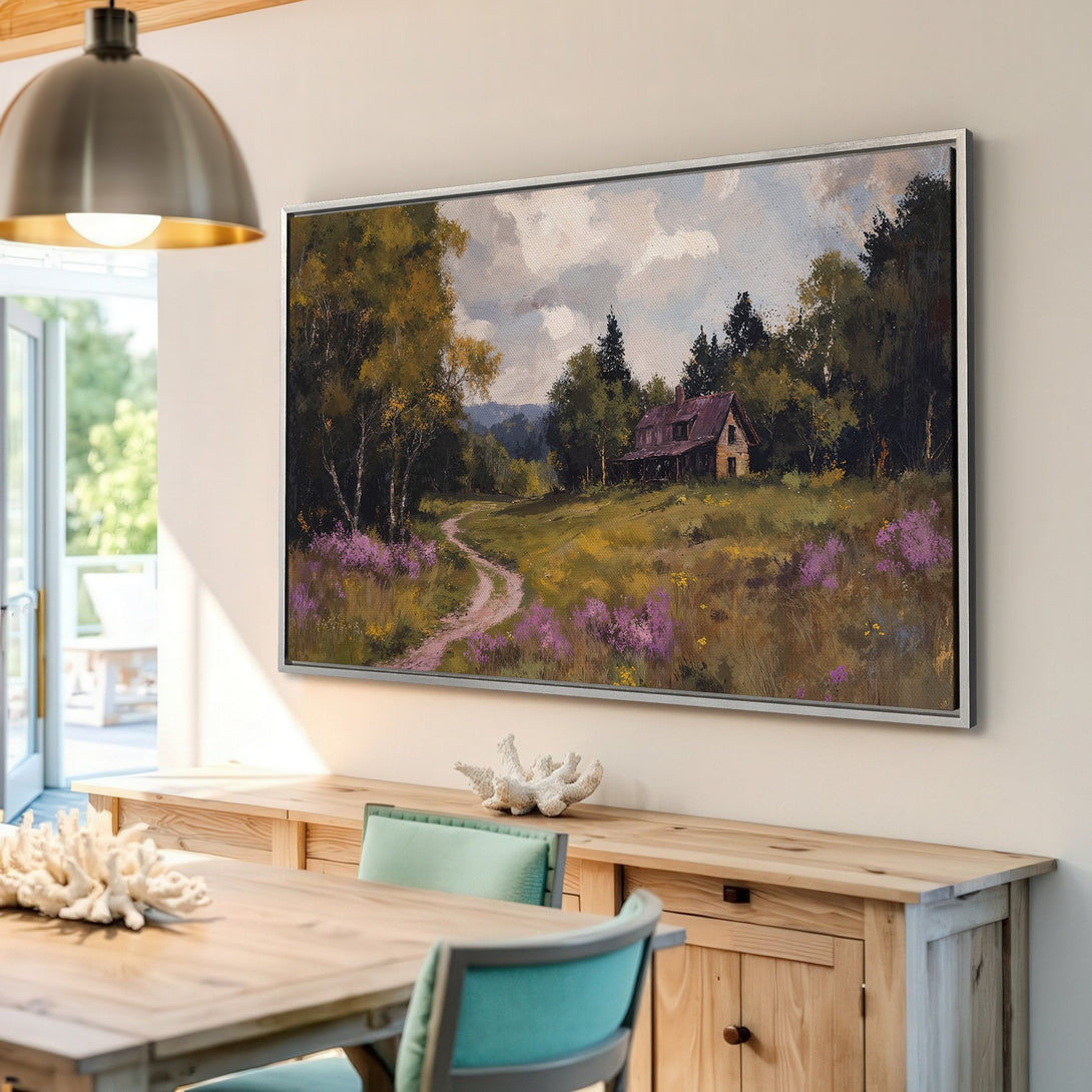 Framed Wall Art: Landscape painting of a cabin in a field. Warm, earthy tones with pops of purple and green. Perfect for rustic decor.