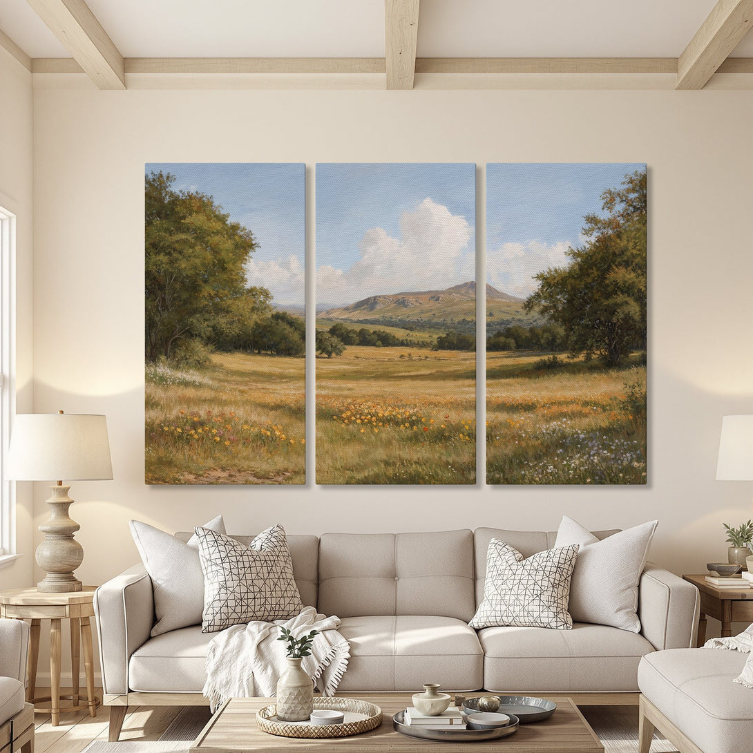 Canvas Print of a serene landscape painting with a warm color palette, displayed in a cozy living room. Featuring a nature scene with fields, trees, and mountains.