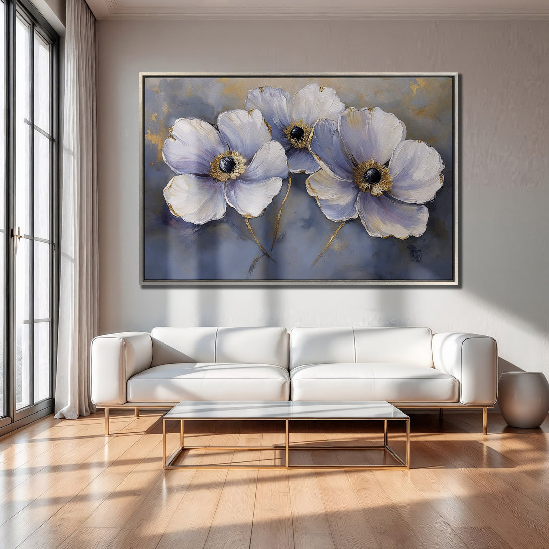 Framed Wall Art of elegant white flowers with gold accents, set in a modern living room. Blue and gold color palette. Perfect home decor.