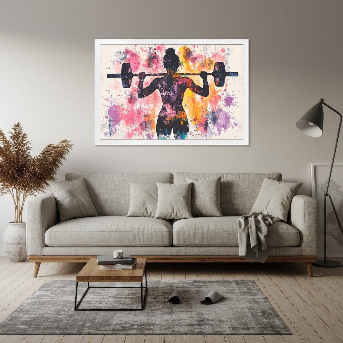 Framed Poster featuring a watercolor silhouette of a woman weightlifting. Vibrant pink, purple, and orange abstract background. Perfect gym decor.