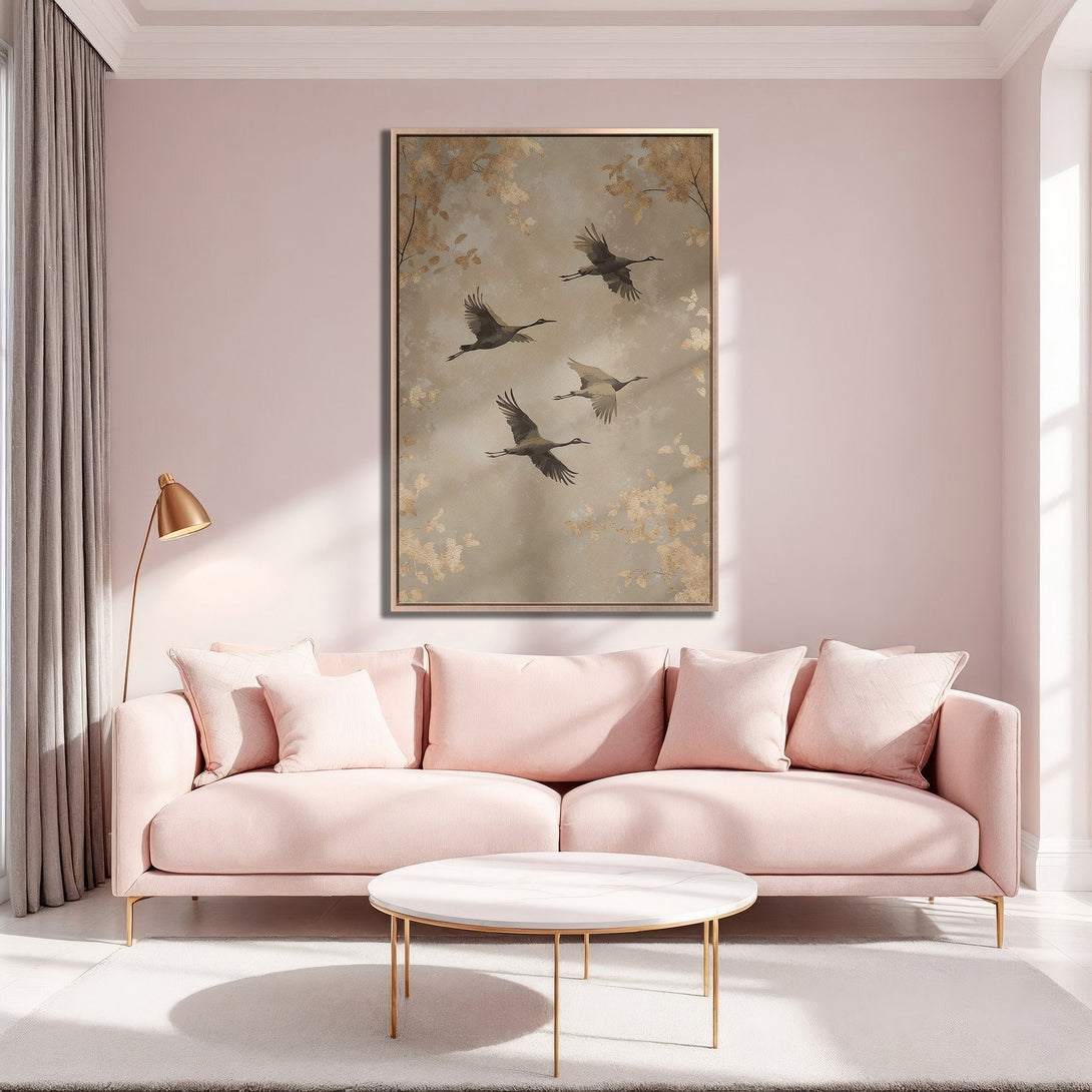 Framed Wall Art featuring elegant cranes in flight. Neutral tones and gold accents complement the soft pink interior. Add a touch of serenity to your space!