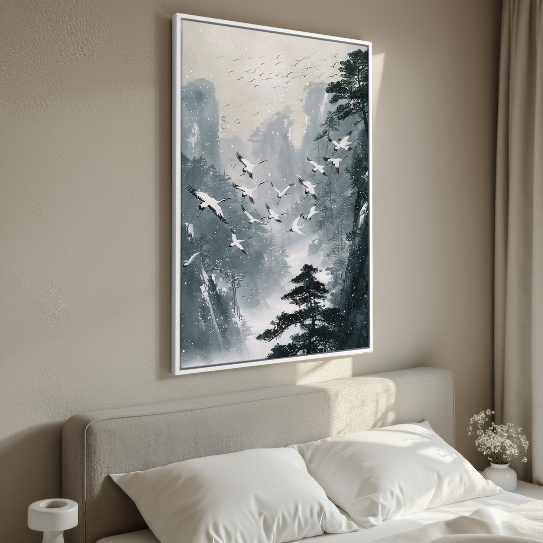 Framed Wall Art: Serene landscape canvas print with flying cranes, in a muted blue, gray, and white palette. Perfect for calming bedroom decor.