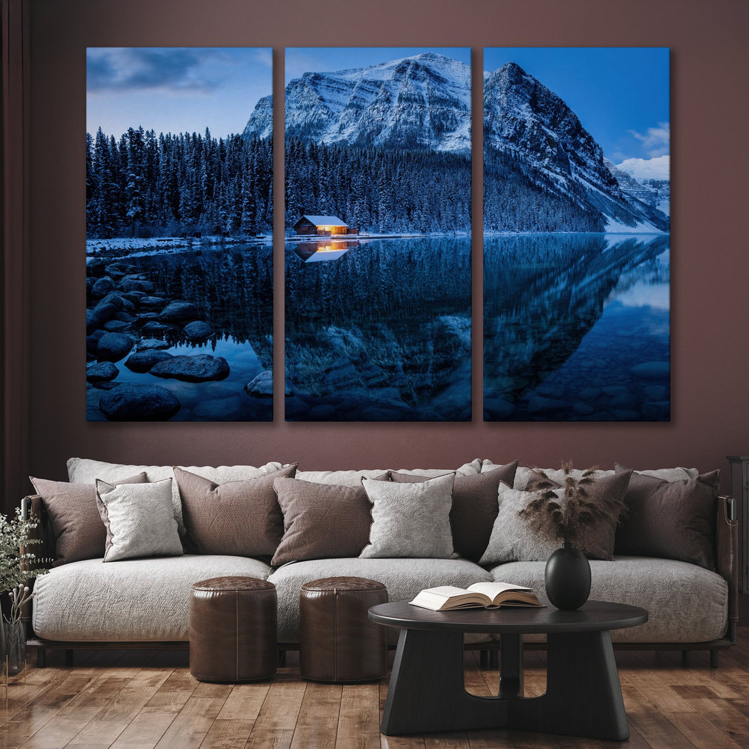 Canvas Print of a serene winter landscape with a cabin, mountain reflection, and cool blue tones. Perfect for adding a touch of nature to your home.