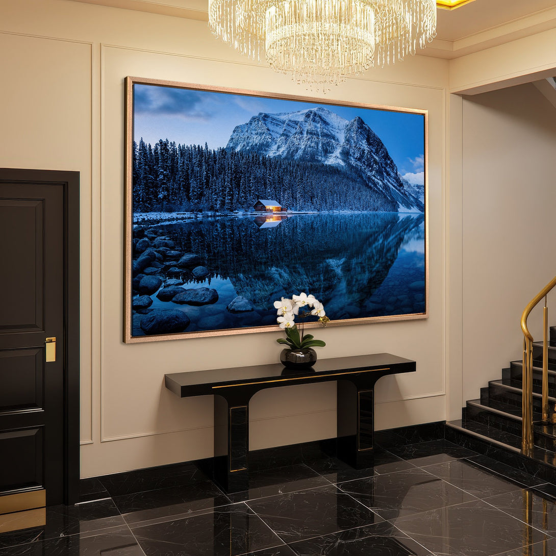 Framed Wall Art: Mountain landscape Canvas Print in blue and white tones, adding a touch of nature to a luxurious interior.