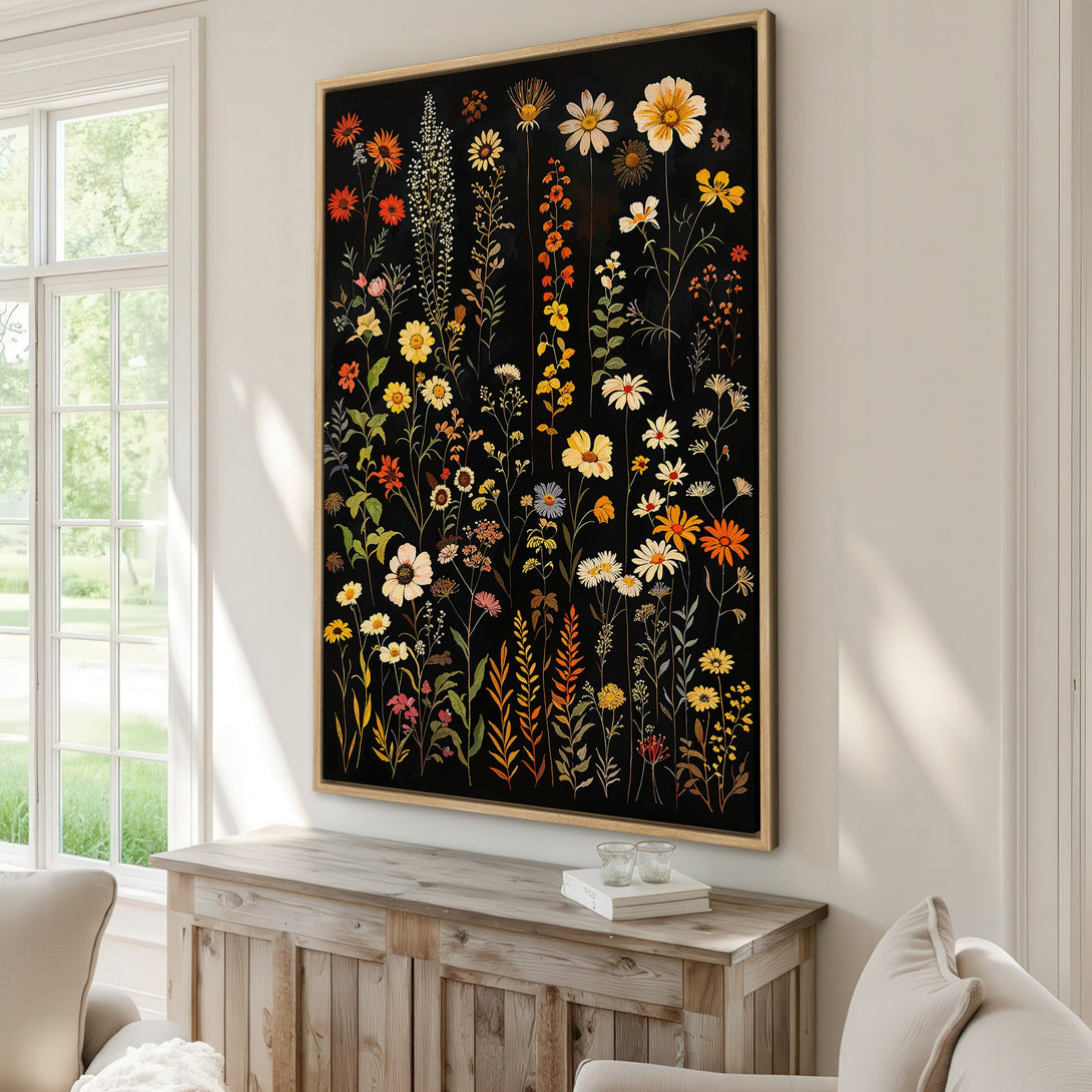 Framed Wall Art featuring a vibrant floral design on a black background. Warm color palette of yellows, oranges, and reds adds a touch of nature to any interior.