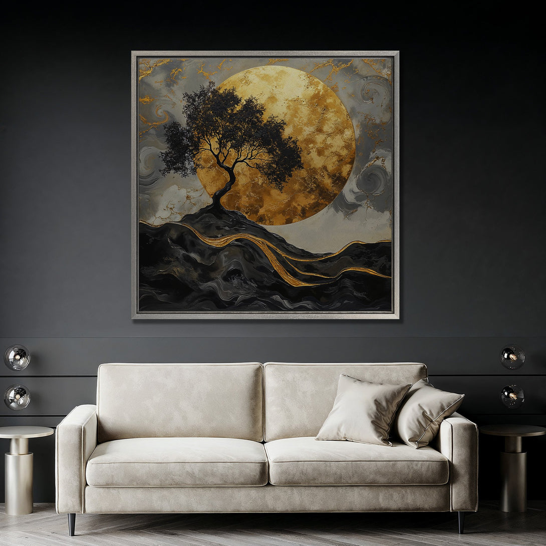 Framed Wall Art featuring a tree silhouette against a golden moon. Abstract style with a dark, moody palette of black, gold, and gray. Perfect for modern decor.
