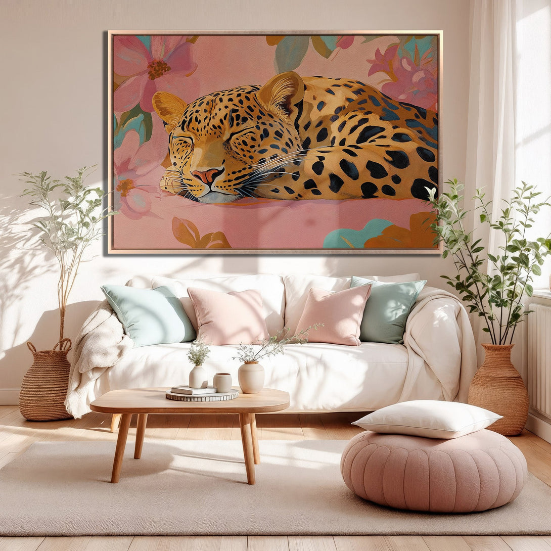 Framed Wall Art: Sleeping leopard print canvas in a modern living room. Features a warm, pink and gold color palette. Perfect for adding a touch of elegance.