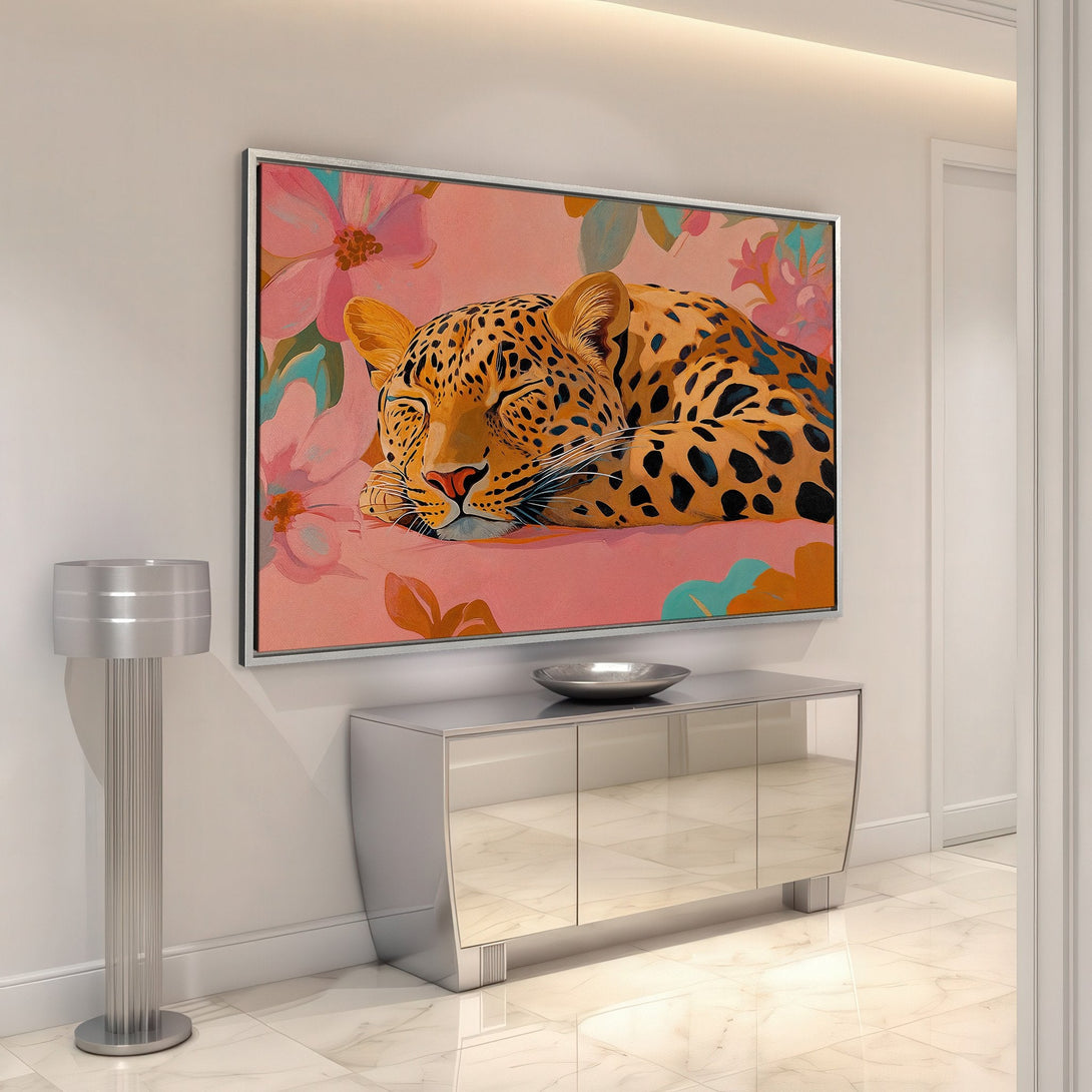 Framed Wall Art: Leopard Canvas Print in a modern interior. Featuring a sleeping leopard with floral accents, warm peach and orange hues. Elevate your space!