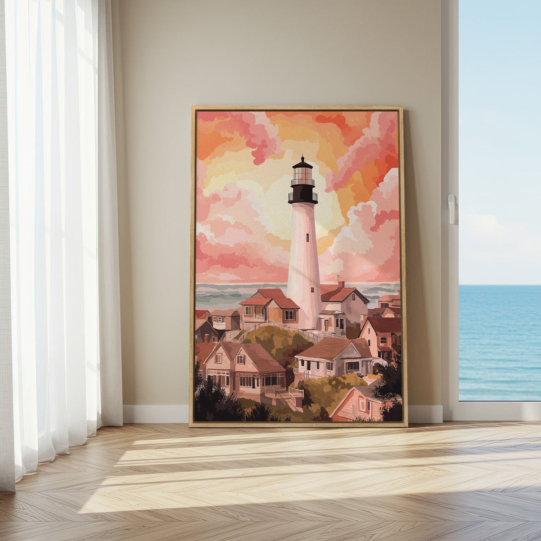 Framed Wall Art featuring a lighthouse and coastal village in warm peach and coral tones. Perfect for adding a touch of serenity to your home decor.