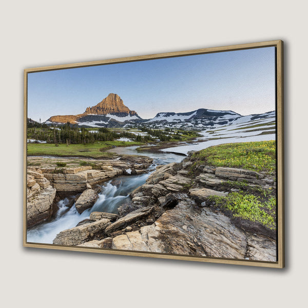 Framed Wall Art of a mountain landscape with a river, featuring a natural color palette of blues, greens, and browns. Bring nature's beauty into your home!