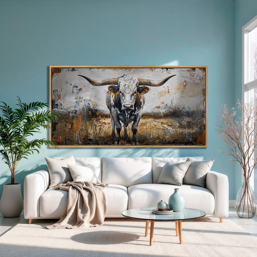Framed Wall Art: Bold bull painting in a modern living room. Featuring a neutral and orange palette, this canvas print adds rustic charm to any space.