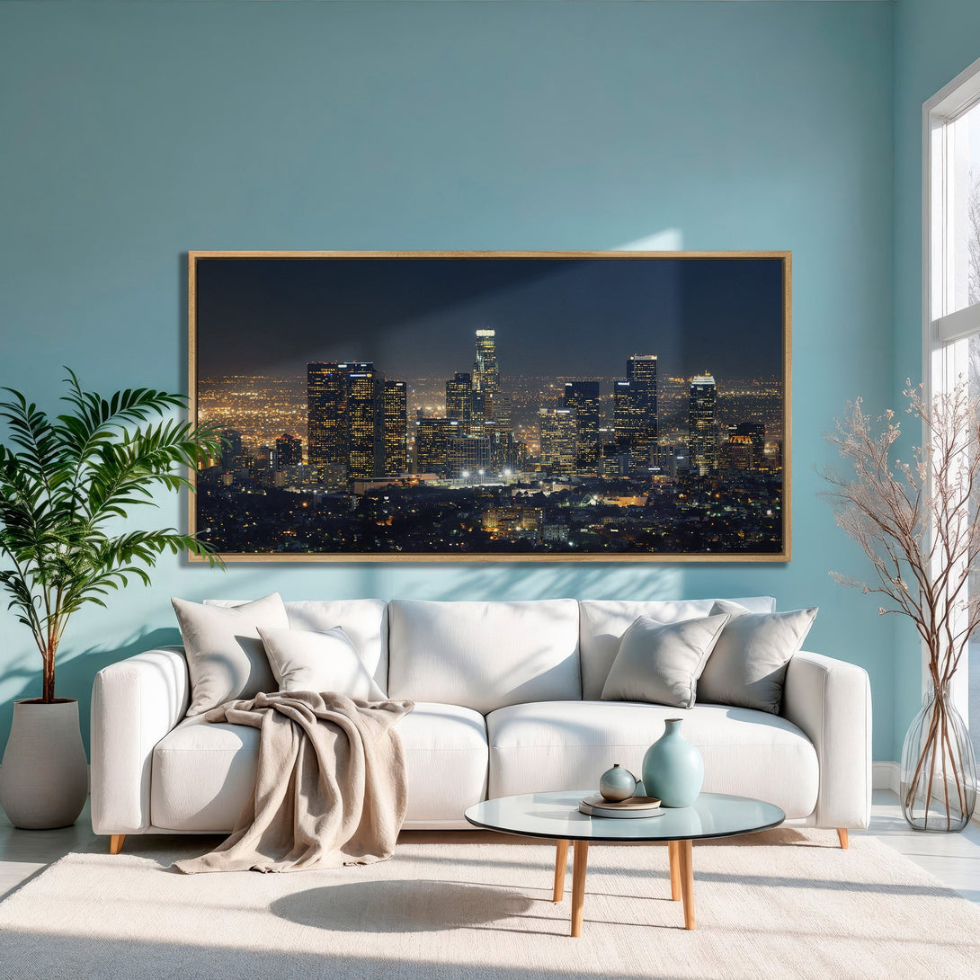 Framed Wall Art: Night cityscape Canvas Print in a modern living room. Features a warm, neutral color palette with pops of gold and blue.
