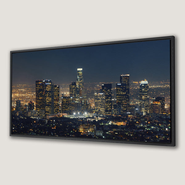Framed Wall Art of Los Angeles skyline at night. Modern, photographic style with a dark blue and gold color palette. Elevate your space with this canvas print!