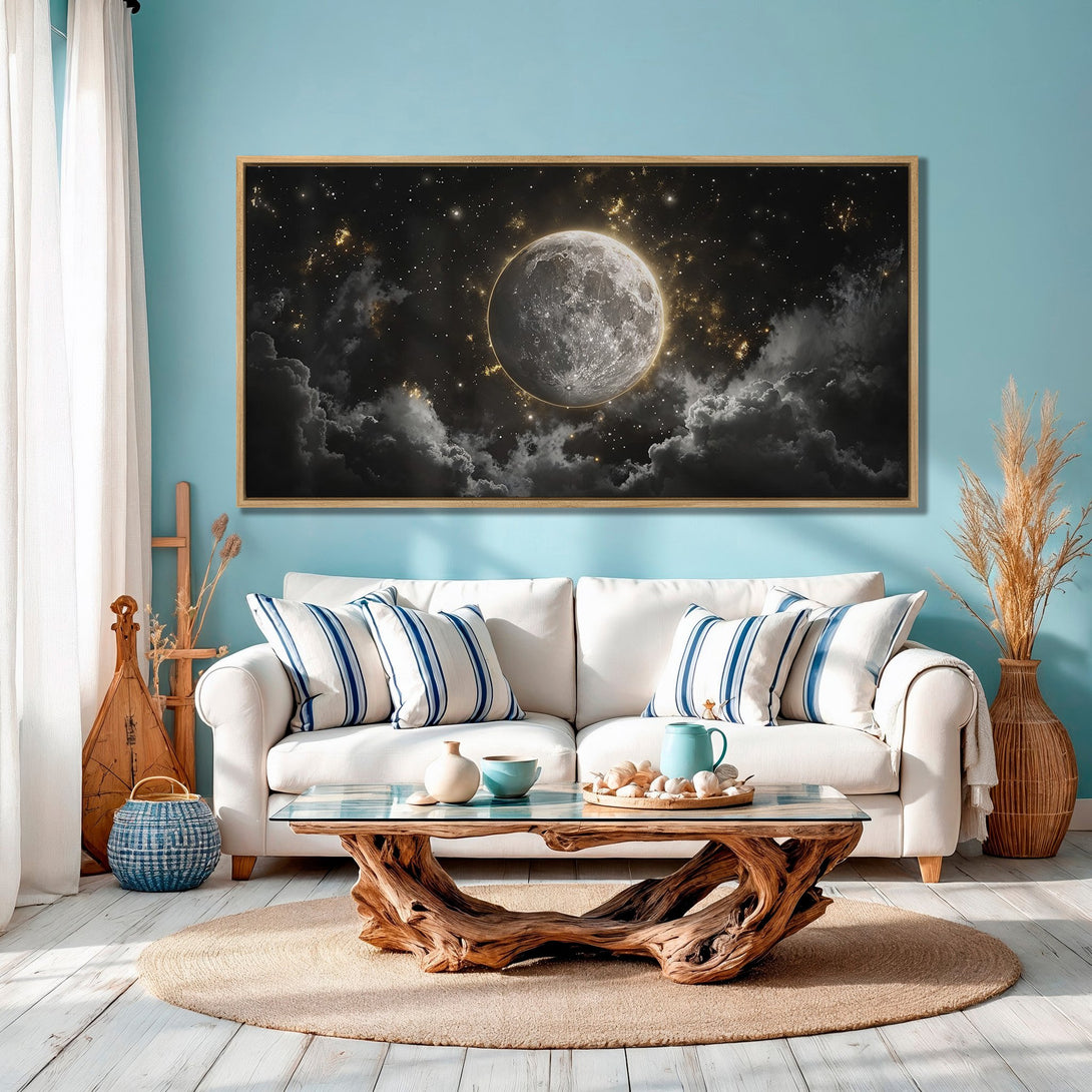 Framed Wall Art: Moonlit night sky canvas print in a modern living room. Black, white, and gold celestial art for home decor.