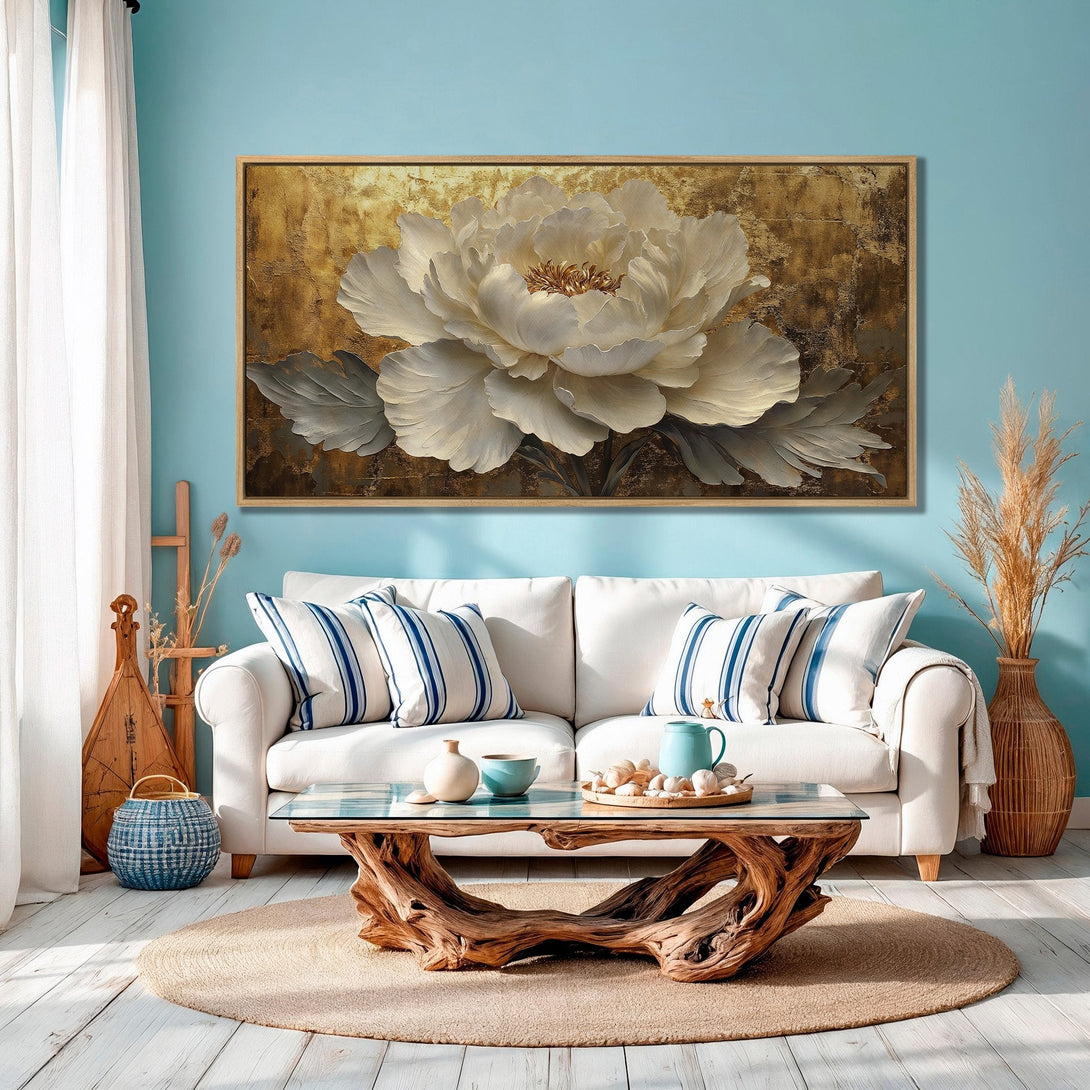 Framed Wall Art featuring a large white flower on a gold background. Elegant, modern decor with neutral and blue tones, perfect for any living room.