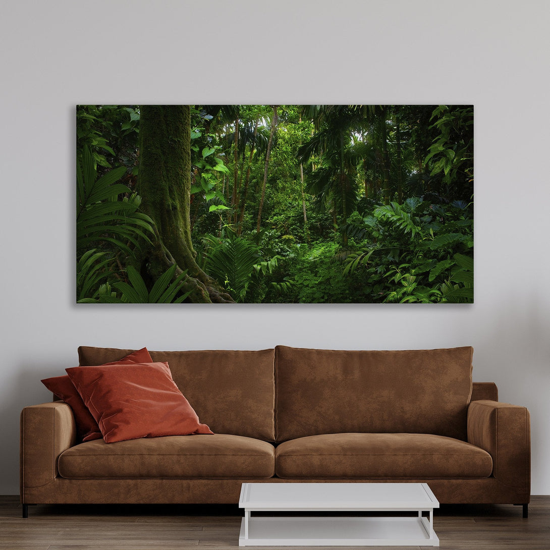 Framed Wall Art: Lush green tropical forest canvas print in a warm, inviting living room. Nature-inspired art with a vibrant, natural color palette.