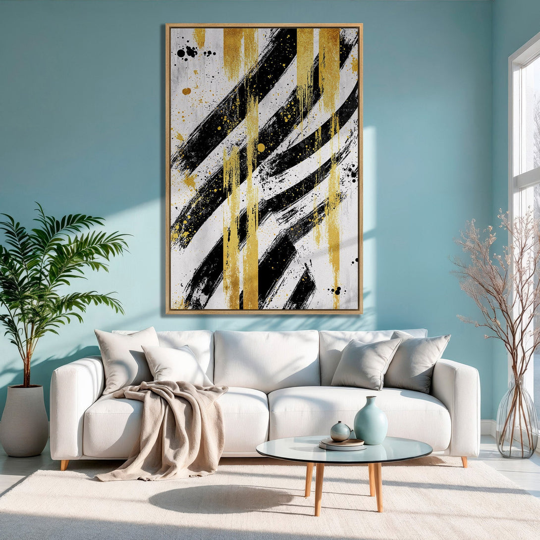 Framed Wall Art: Abstract black, gold, and white brushstrokes on a canvas print. Modern art for living room decor with a neutral color palette.