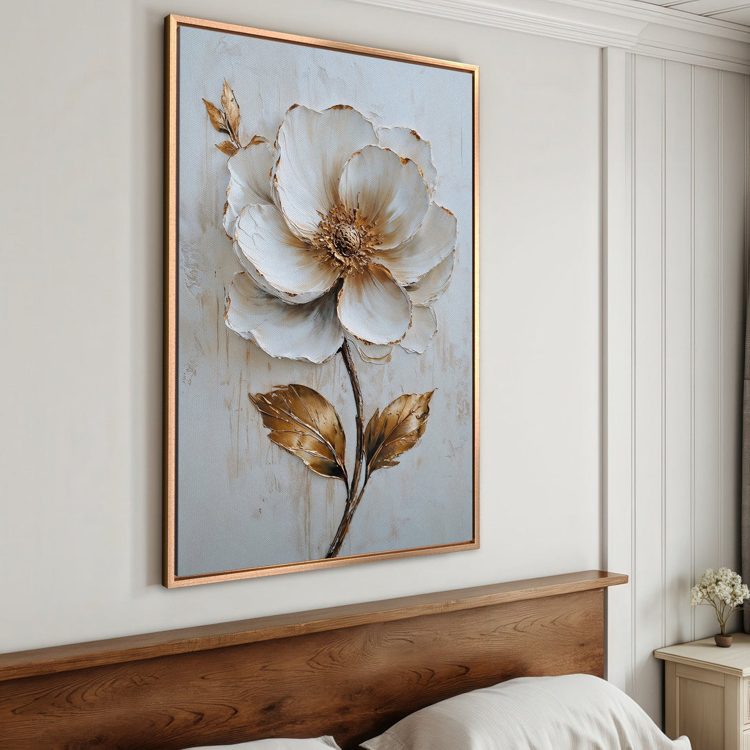 Framed Wall Art featuring a large, textured white flower with gold accents. Elegant decor with a neutral, warm color palette. Perfect for bedroom or living room.