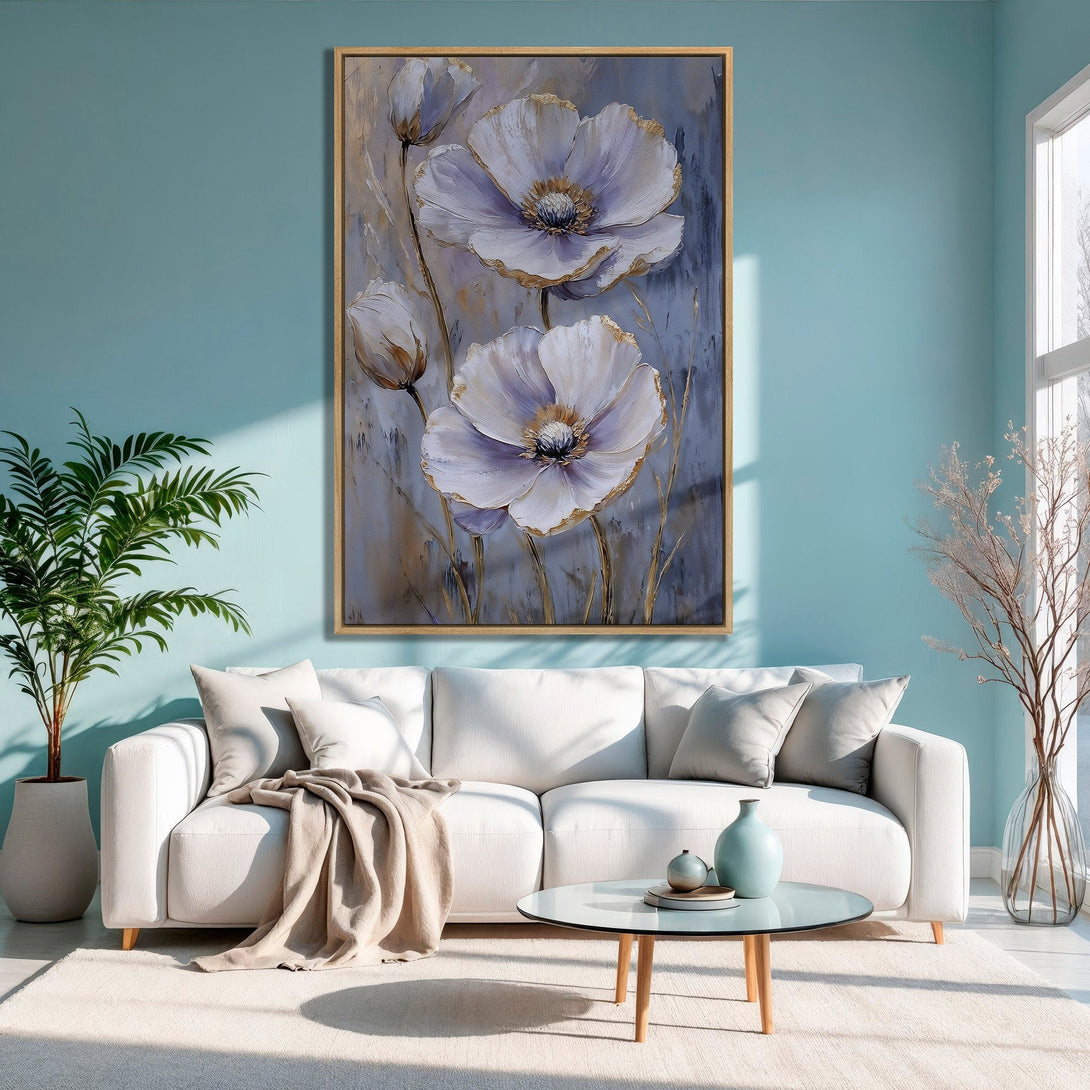 Framed Wall Art: Elegant floral painting with white and gold accents, displayed in a modern living room with a soft blue color palette.