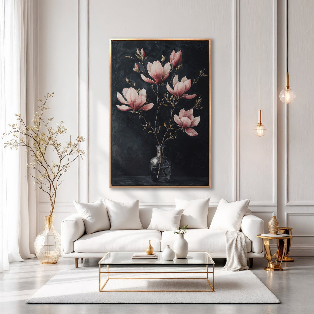 Framed Wall Art: Elegant floral painting in a modern living room. Features pink magnolia blossoms on a dark background, gold frame, & neutral color palette.