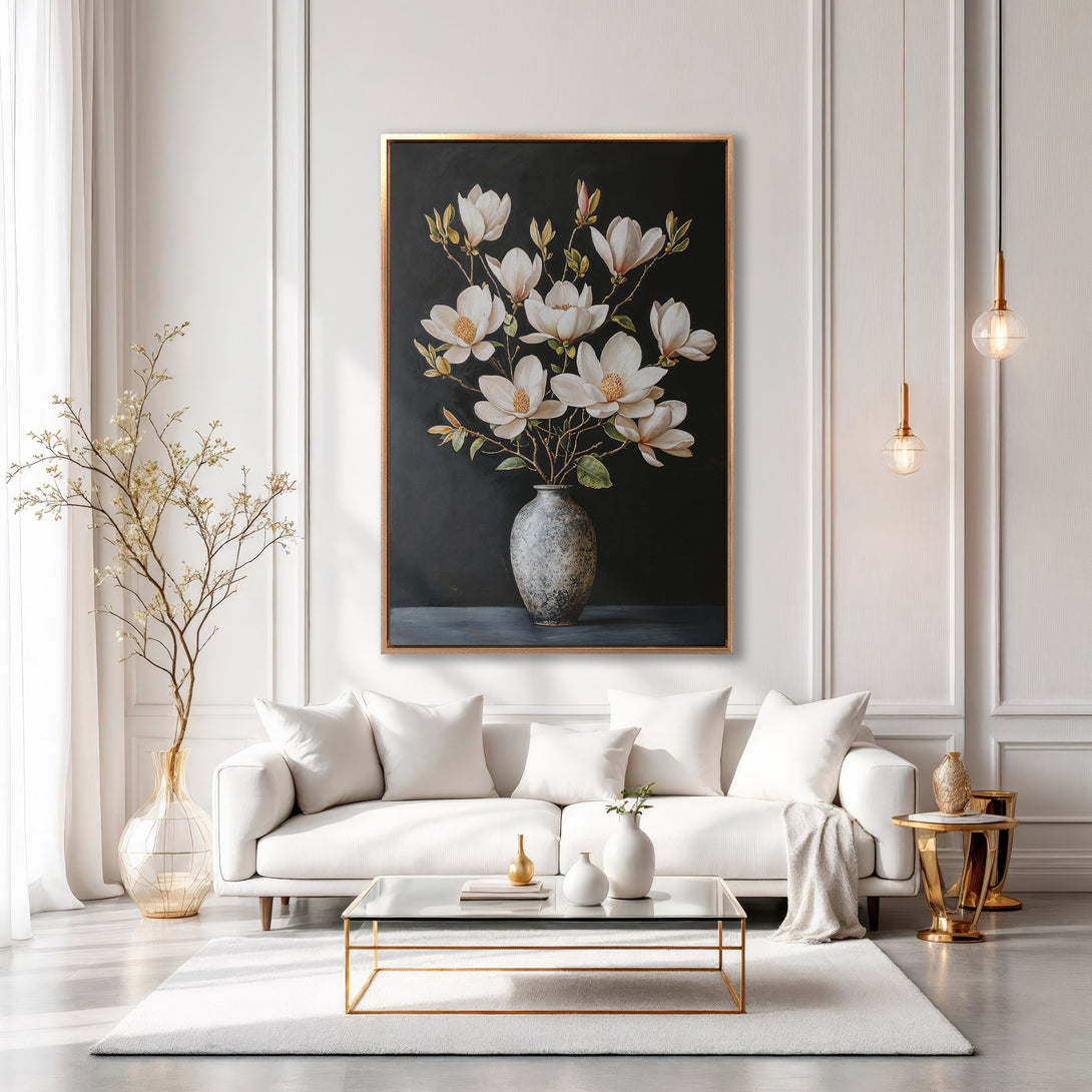 Framed Wall Art: Elegant magnolia floral print in a modern interior. Features a dark background with white flowers, gold frame, and neutral color palette.