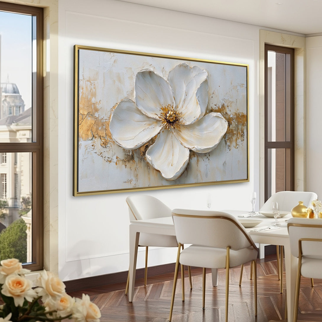 Canvas Print of a white flower painting with gold accents, displayed in a room with a green and brown color palette. Modern floral wall art.