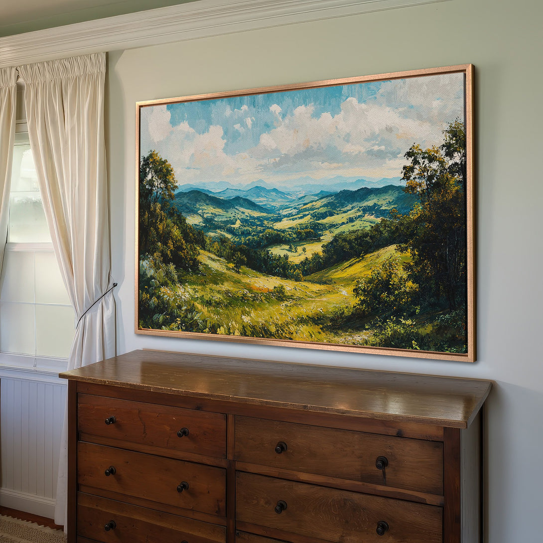 Framed Wall Art: Landscape painting of rolling green hills and blue skies. Rustic style with warm, natural color palette. Perfect home decor accent.
