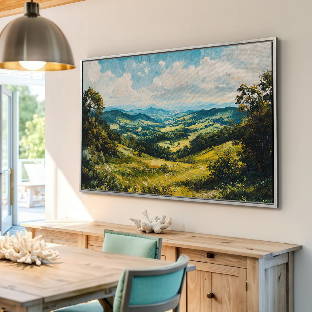 Framed Wall Art: Landscape painting in a dining room. Features rolling hills, blue sky, and a green/yellow color palette. Perfect for home decor!