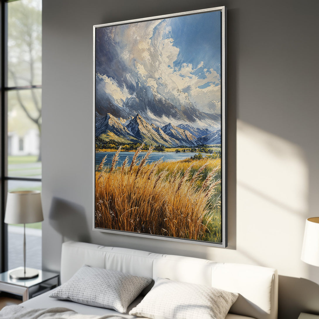 Framed Wall Art: Mountain landscape canvas print in a bedroom. Features a dramatic sky, blue lake, and golden grasses. Earthy tones with a touch of blue.