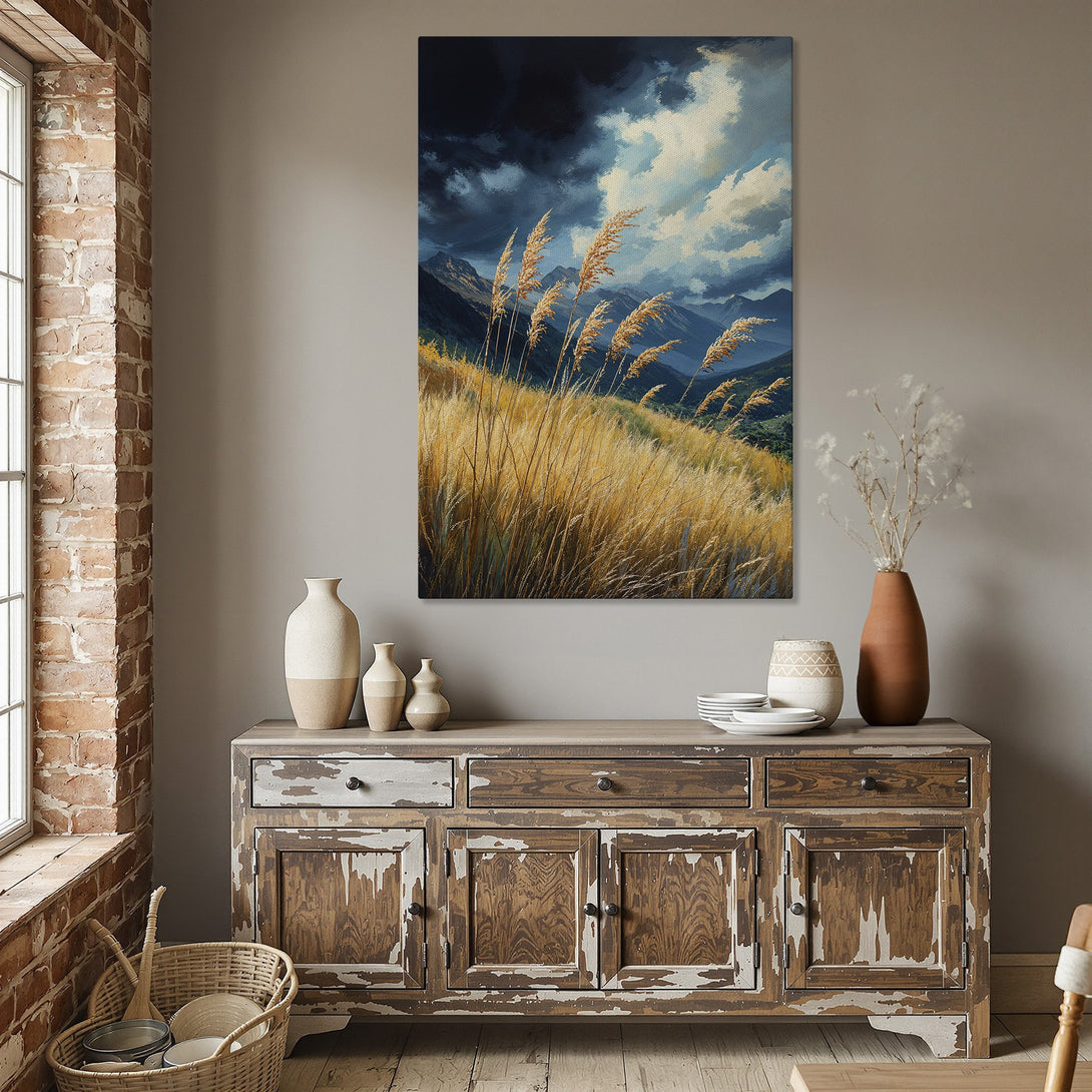Framed Wall Art: Dramatic landscape Canvas Print with golden grasses, mountains, and moody blue skies. Earthy color palette adds warmth to any room.