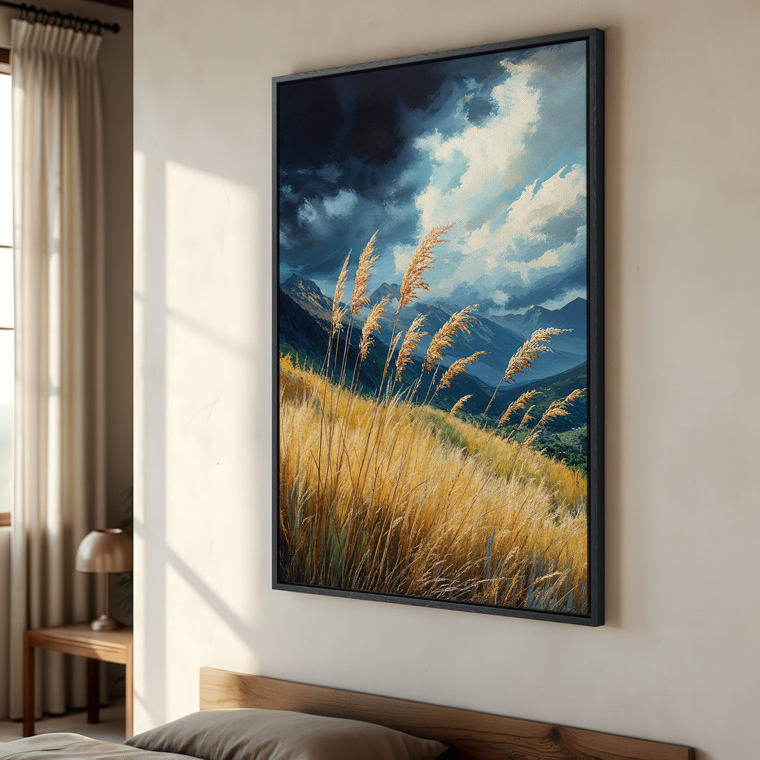 Framed Wall Art featuring a landscape of golden grasses and mountains under a dramatic sky. Earthy tones and a touch of blue create a serene aesthetic.