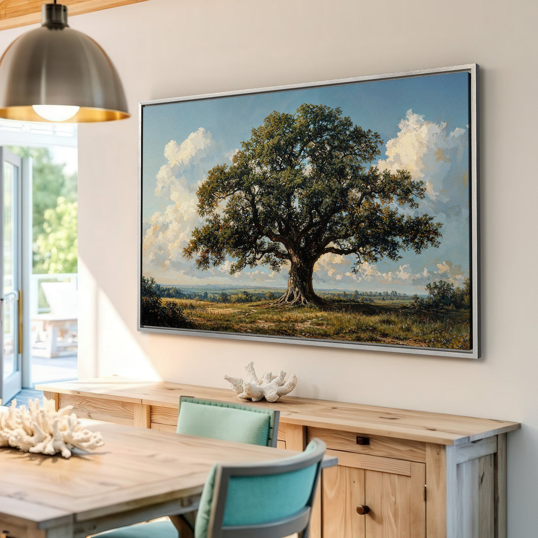 Framed Wall Art featuring a classic landscape painting of a large oak tree, displayed in a bright interior. Earthy tones and blue sky.