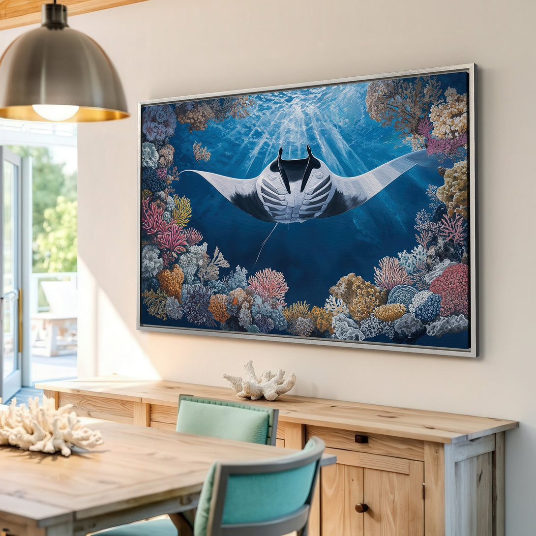 Framed Wall Art featuring a majestic manta ray swimming in a vibrant coral reef. Stunning blue, pink, and coral color palette. Perfect for coastal decor.
