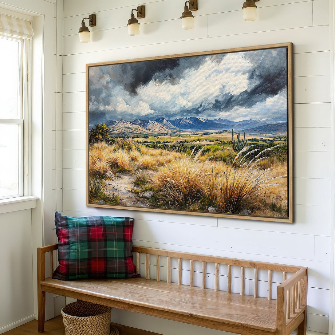 Framed Wall Art featuring a landscape painting with mountains, golden grasses, and a moody sky. Earthy tones create a warm, inviting atmosphere.
