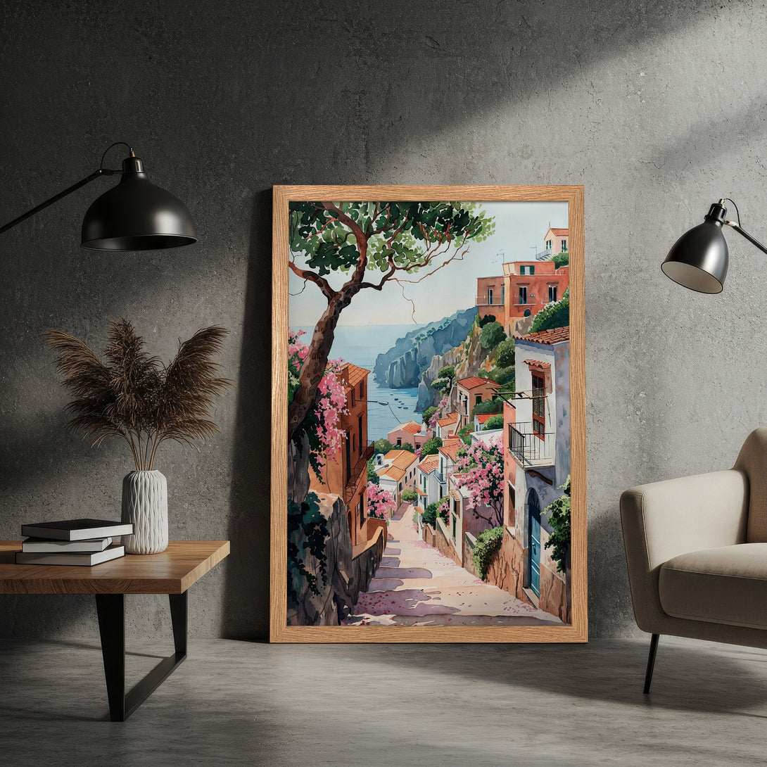 Framed Poster of a charming Italian coastal town in watercolor style. Features warm tones, pink blossoms, and a serene blue sea. Perfect wall art!