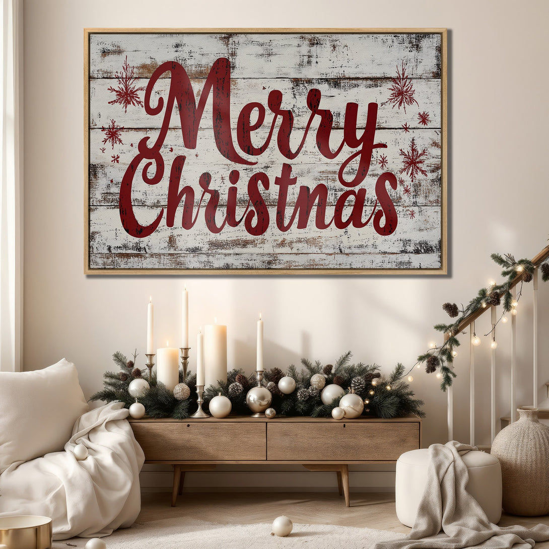 Framed Wall Art: "Merry Christmas" canvas print in a rustic style, red lettering on a white wood background. Warm neutral interior with festive decor.