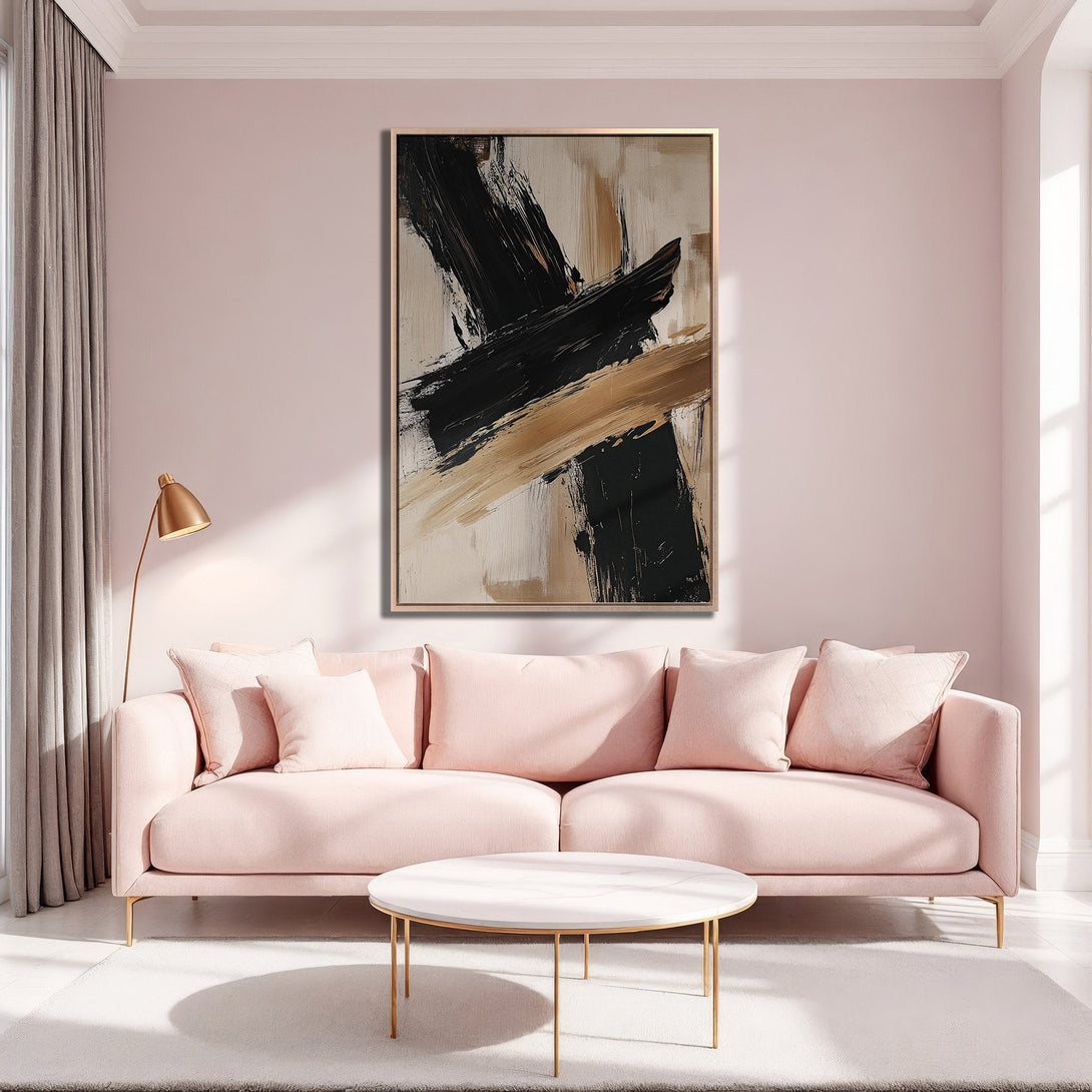 Framed Wall Art: Abstract black, beige, and gold brushstrokes. Modern art canvas print in a stylish living room with a pink sofa. Perfect for home decor.